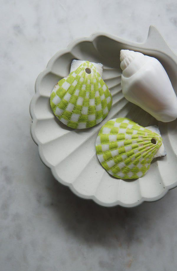 Lime green handpainted shell earrings in a checkered pattern in a shell