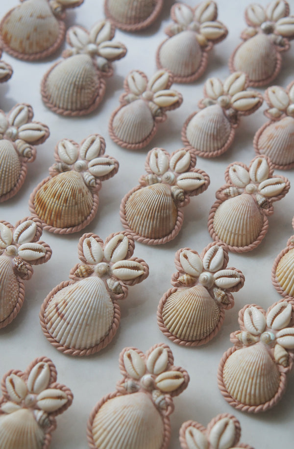 multiple pairs of tan and rose pink polymer clay earrings