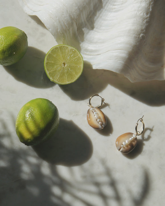 shell with pearls earring charms displayed with limes