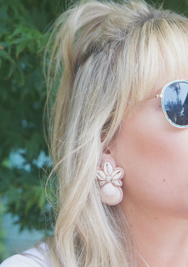 shell and polymer clay earrings worn by woman with long blond hair in sunglasses